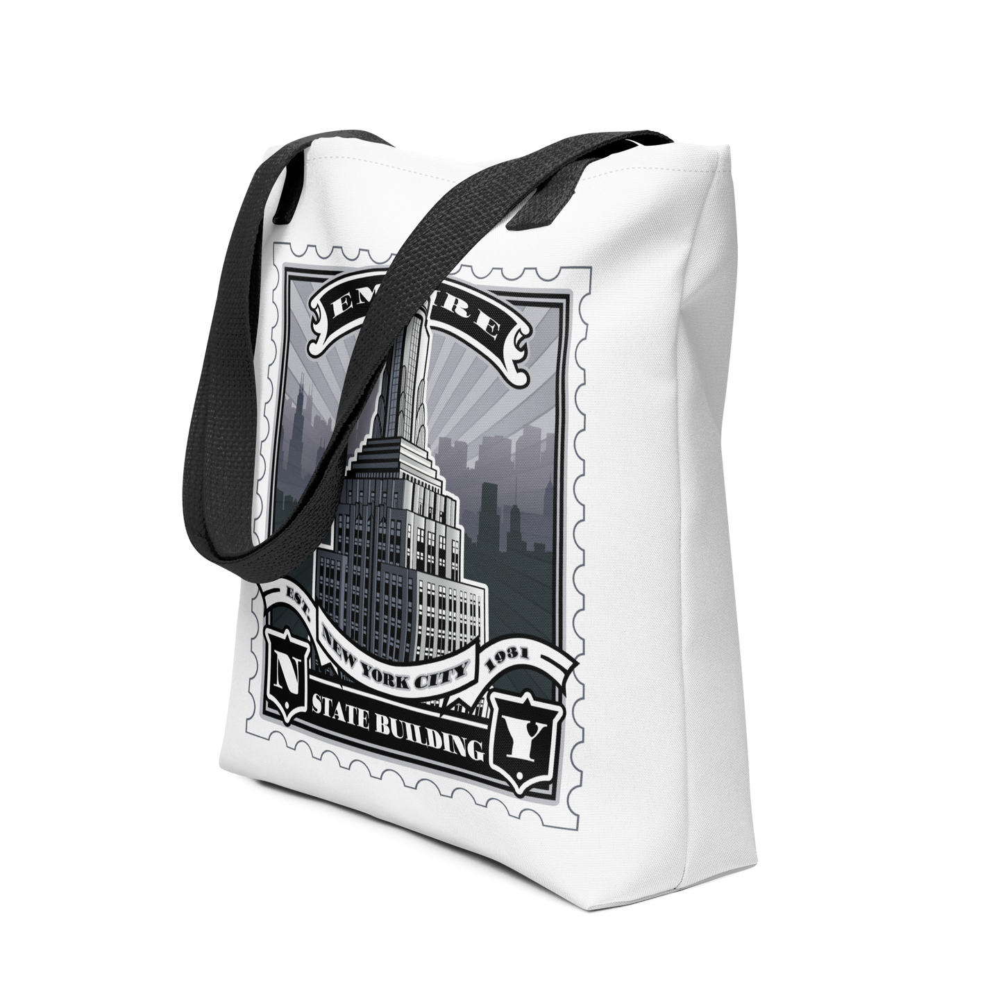White canvas tote with Empire State Building vintage stamp illustration, black handles, detailed skyline silhouette.