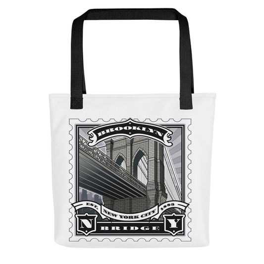 White canvas tote with Brooklyn Bridge vintage stamp illustration, black handles, detailed Gothic arches and suspension cables.