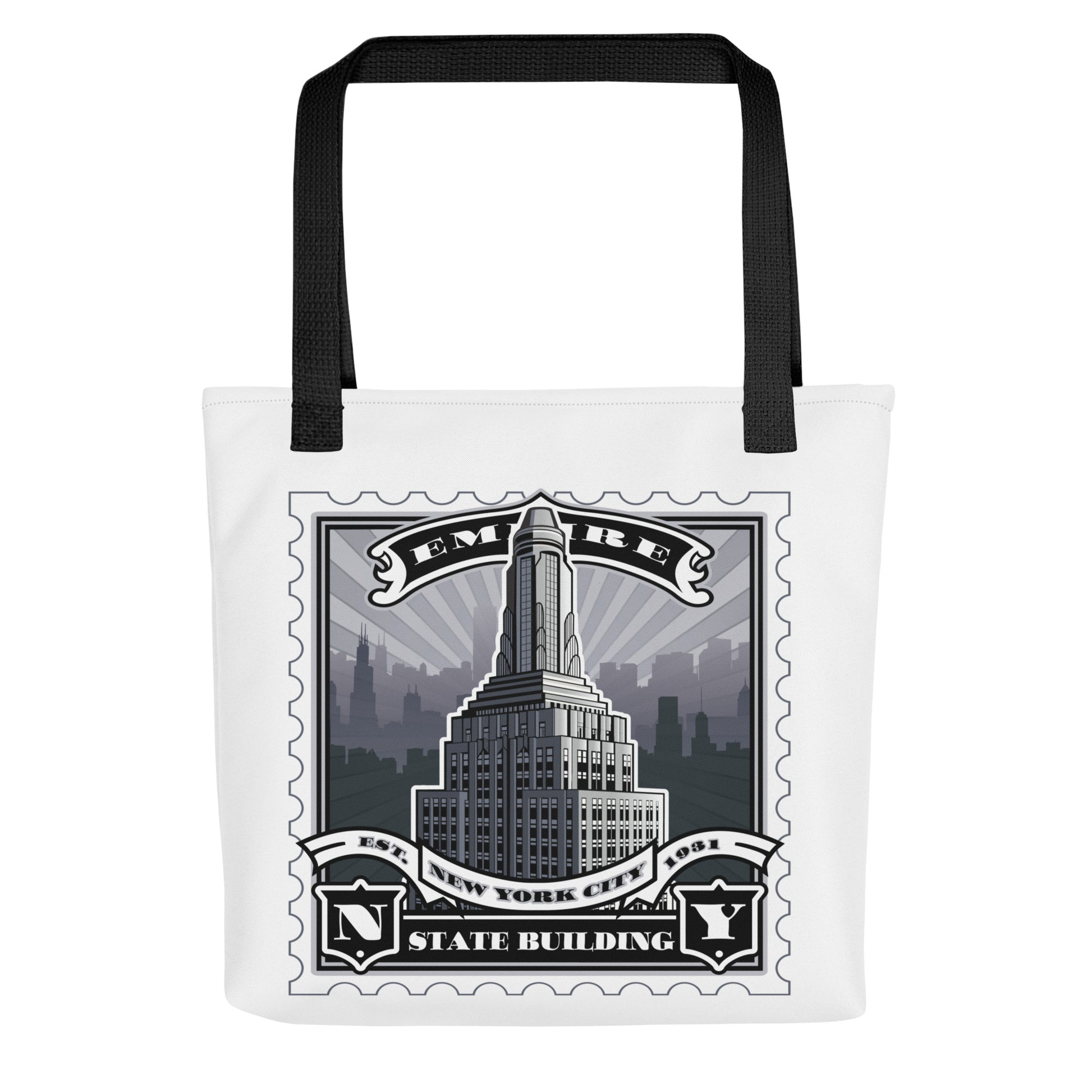 White canvas tote with Empire State Building vintage stamp illustration, black handles, detailed skyline silhouette.
