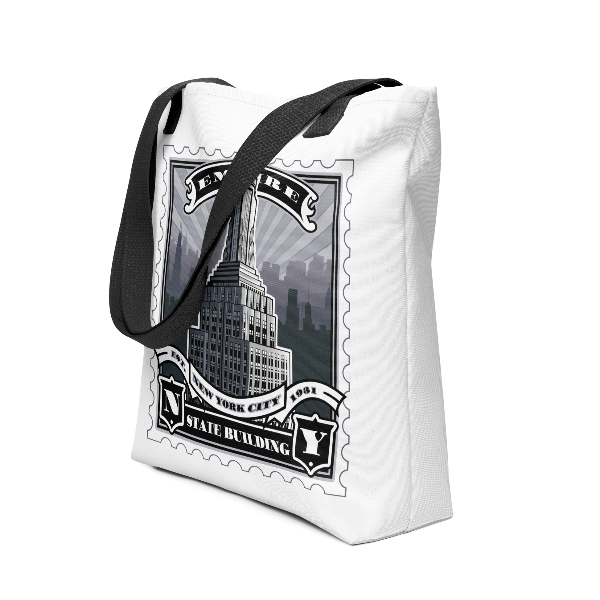 White canvas tote with Empire State Building vintage stamp illustration, black handles, detailed skyline silhouette.